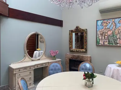 a room with a table and a mirror and a fireplace at Hotel Rústico San Jaime in Ourense