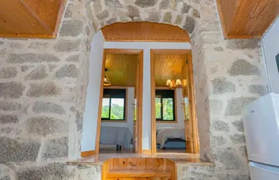 a room with a stone wall and a doorway at Cabana do Sil in Forcas
