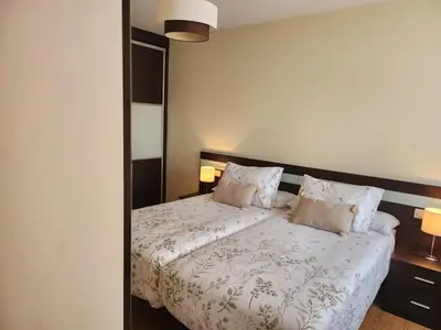 a bedroom with a white bed with two pillows at SayCa CREDENCIAL in Sarria