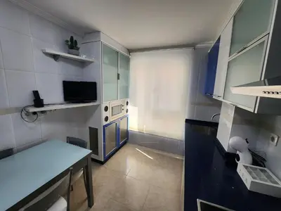 a small kitchen with a table and a television at SayCa CREDENCIAL in Sarria