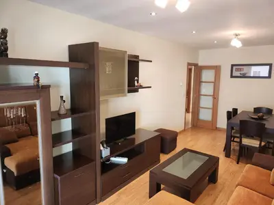 a living room with a television and a table at SayCa CREDENCIAL in Sarria