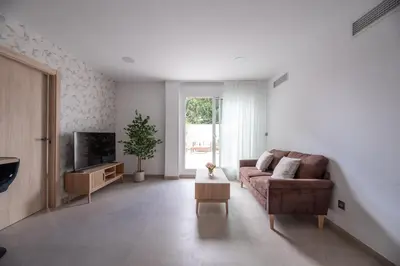 a living room with a couch and a tv at NUBA apartamentos turísticos in Monforte de Lemos