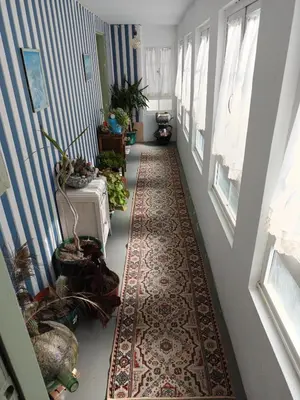 a hallway with a rug on the floor and windows at Casa Nodar in Chantada