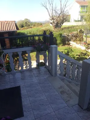 a white fence with flowers on a patio at Casa Nodar in Chantada
