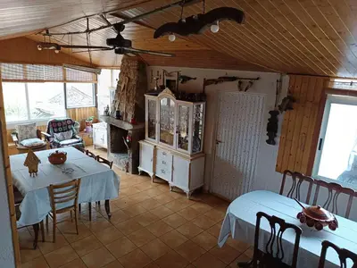 a dining room with two tables and chairs in a room at Casa Nodar in Chantada