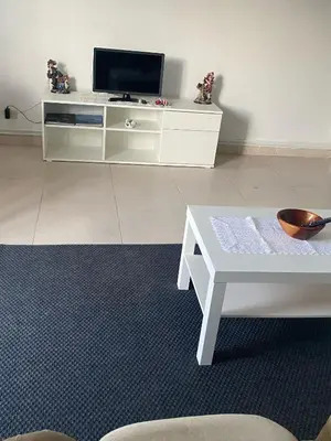 a living room with a tv and a white table at Casa Trasande in Couso