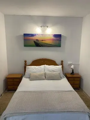 a bedroom with a bed with a painting on the wall at Casa Trasande in Couso