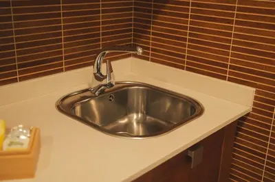 a sink with a faucet on top of a counter at Apartamento Casco Histórico in Viveiro