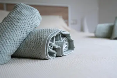 a close up of a blanket on a bed at Apartamento Casco Histórico in Viveiro