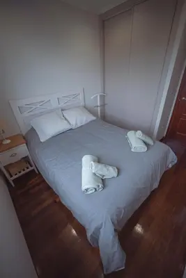 a bedroom with a bed with towels on it at Apartamento Casco Histórico in Viveiro