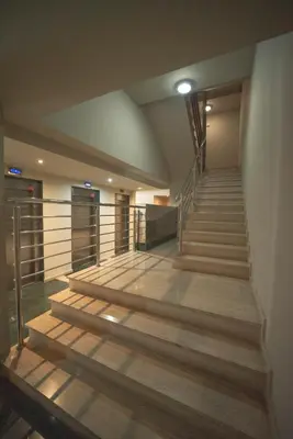 a staircase in a building with wooden floors and rails at Apartamento Casco Histórico in Viveiro