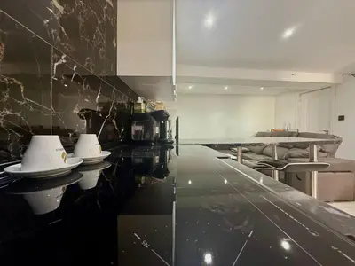 a kitchen with a glass counter top in a room at Casa Vidán completa Santiago Rural in Santiago de Compostela