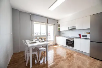 a kitchen with a table and chairs in a room at Atico centrico con terrazas in Monforte de Lemos