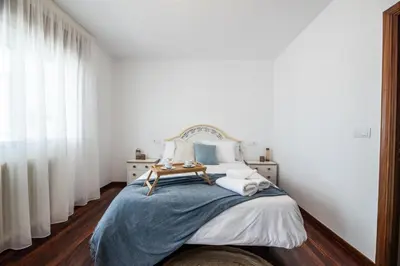 a bedroom with a bed with a blue blanket at Atico centrico con terrazas in Monforte de Lemos