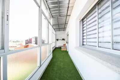 a hallway with large windows and green grass at Atico centrico con terrazas in Monforte de Lemos