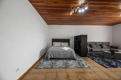 a bedroom with a bed and a couch at Atico centrico con terrazas in Monforte de Lemos