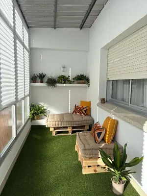a living room with green carpeted floors and windows at Atico centrico con terrazas in Monforte de Lemos