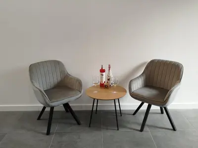 two chairs and a table with wine glasses on it at Hotel Zura in Seoane