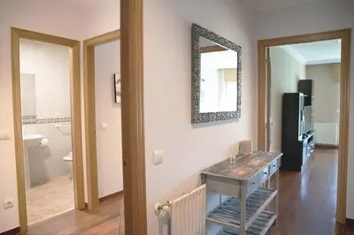 a living room with a mirror on the wall at Apartamento Mónaco in Santiago de Compostela