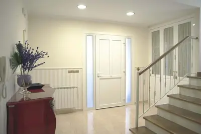 a hallway with a door and stairs in a house at Casa das Buceleiras in Amés