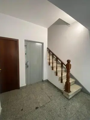 a hallway with a staircase and a door in a house at O nido de David, un refuxio urbano na Ribeira Sacra in Monforte de Lemos