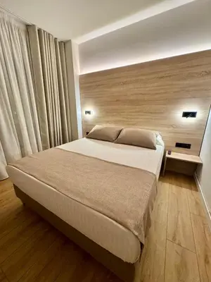 a bedroom with a large bed in a room at Miramar Suites in Sada