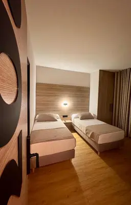 a hotel room with two beds in a room at Miramar Suites in Sada