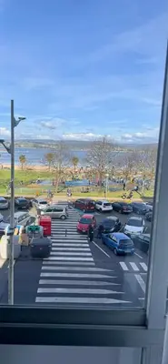 a parking lot with cars parked in a parking lot at Miramar Suites in Sada