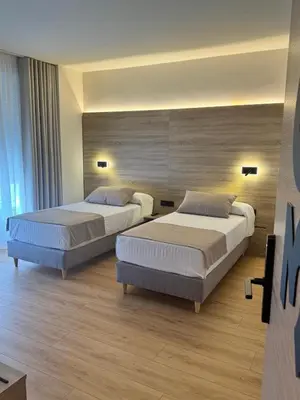 a bedroom with two beds in a room at Miramar Suites in Sada