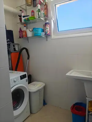 a laundry room with a washing machine and a window at Apartamento casa Chilin in Sarria