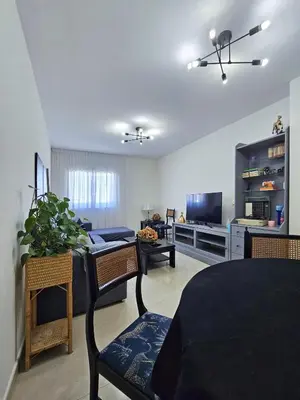 a living room with a couch and a dining room at Apartamento casa Chilin in Sarria