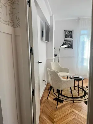 a living room with two chairs and a table at O Victoriano in Caldas de Reis
