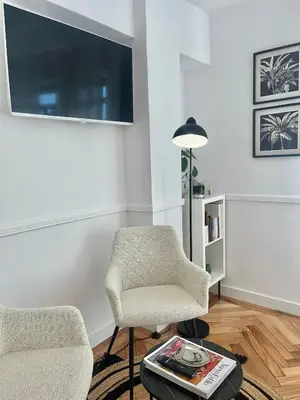 a living room with two chairs and a tv at O Victoriano in Caldas de Reis