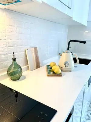 a kitchen counter with a tea kettle and lemons on it at O Victoriano in Caldas de Reis