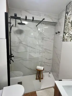 a shower with a glass door in a bathroom at O Victoriano in Caldas de Reis