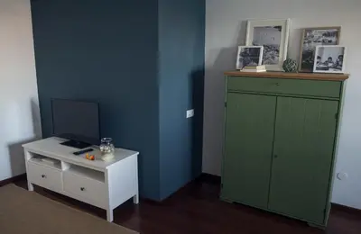a room with a green cabinet and a white table at A Casa do Porto in Burela de Cabo