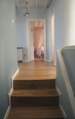 a hallway with a staircase leading to a bedroom at A Casa do Porto in Burela de Cabo