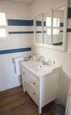 a bathroom with a white sink and a mirror at A Casa do Porto in Burela de Cabo