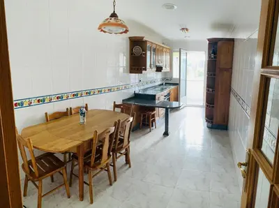 a kitchen with a wooden table and chairs at apartamento céntrico y fabuloso en Ribadeo para vacaciones in Ribadeo