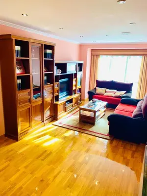 a living room with a couch and a tv at apartamento céntrico y fabuloso en Ribadeo para vacaciones in Ribadeo