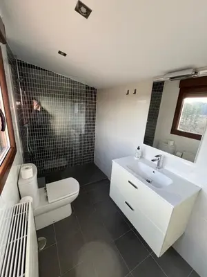 a bathroom with a white sink and a toilet at Casa Victoriano in Melide