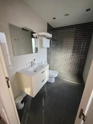 a bathroom with a white sink and a toilet at Casa Victoriano in Melide
