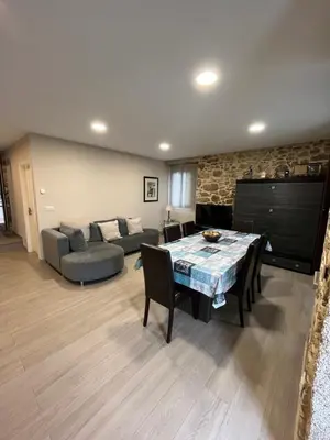 a living room with a table and a couch at Casa Victoriano in Melide