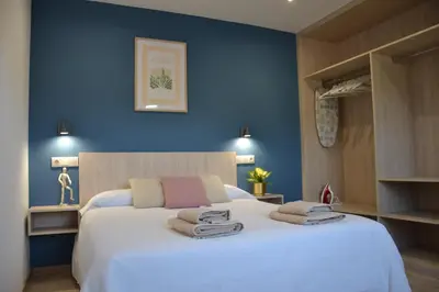 a bedroom with a large bed with towels on it at Avío Apartamentos in Santiago de Compostela