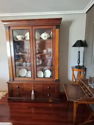 a wooden cabinet with dishes in it in a living room at Duplex A Mosquera by Foroplaza Pleno centro Vistas muralla in Lugo