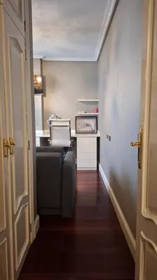 a hallway of a kitchen with a couch in a room at Duplex A Mosquera by Foroplaza Pleno centro Vistas muralla in Lugo