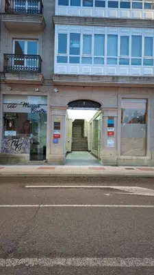 a building with a tunnel in the middle of a street at Duplex A Mosquera by Foroplaza Pleno centro Vistas muralla in Lugo