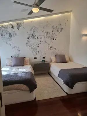 two beds in a room with a map on the wall at Duplex A Mosquera by Foroplaza Pleno centro Vistas muralla in Lugo