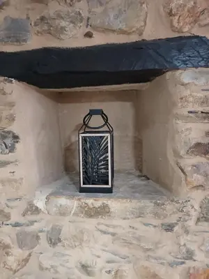 a lantern hanging on a stone wall at Él Rincón de los Sueños A in Vegadecabo