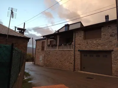 a brick house with a garage on a street at Él Rincón de los Sueños A in Vegadecabo